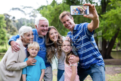 Multi-generation family taking a selfie in the park