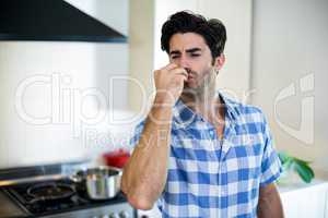 Man  giving a flying kiss in kitchen