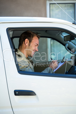 Delivery man sitting in his van