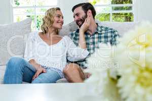 Romantic young couple sitting on sofa