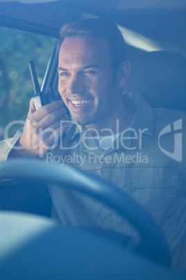 Delivery driver talking on walkie-talkie