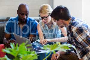 Colleagues interact using laptop