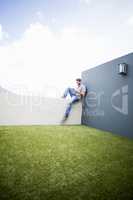 Man sitting on terrace using digital tablet