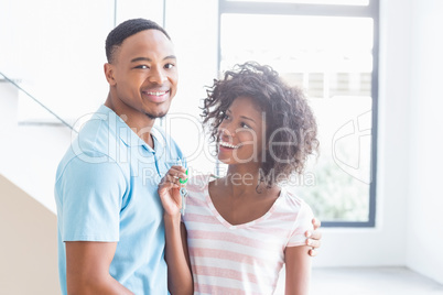 Young couple showing their house key