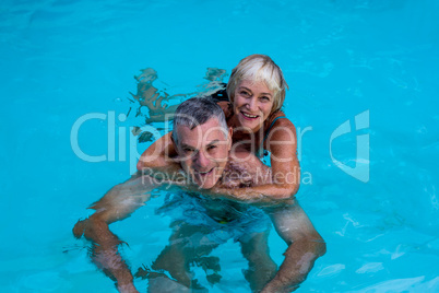 Senior couple enjoying in swimming pool