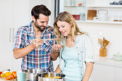 Young couple tasting food