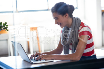 Happy woman using laptop