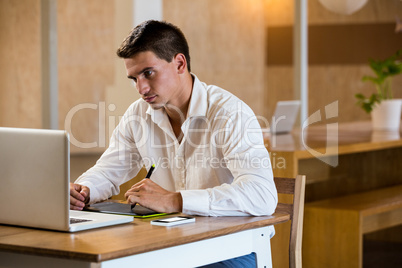 Man working on his graphics tablet Man working on his graphics tablet