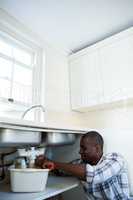 Man repairing a kitchen sink