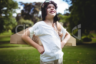 Happy girl standing in the park with hand on hip