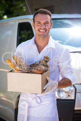 Delivery man standing in front of his van