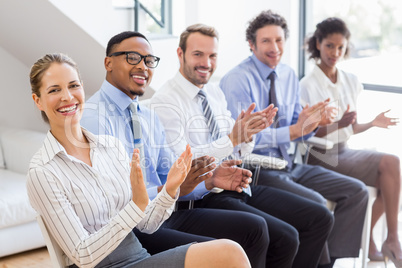 Businesspeople applauding while in a meeting