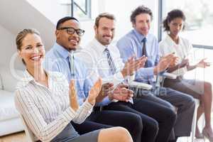 Businesspeople applauding while in a meeting