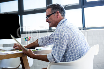 Happy man using digital tablet