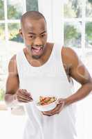 Portrait of young man having breakfast cereals