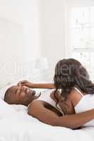 Young couple cuddling in the bedroom