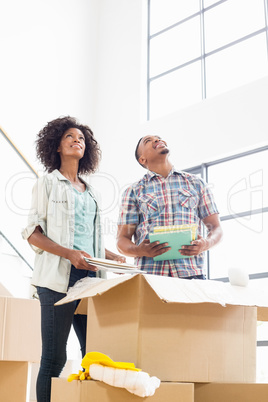 Young couple unpacking carton boxes