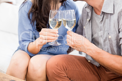 Young couple toasting wine glasses