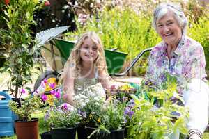 Portrait of grandmother and granddaughter gardening together