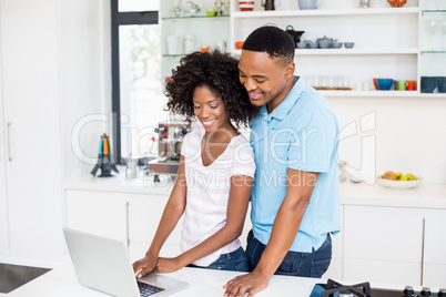 Happy couple using laptop