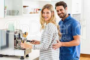 Young couple preparing coffee from coffeemaker