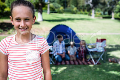 Portrait of a girl standing outside a tent