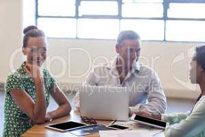 Young men and women sitting at their desk