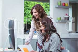 Two beautiful woman using computer