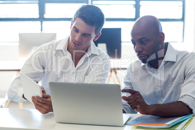 Colleagues working together at their desk