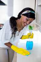 Happy woman cleaning the kitchen