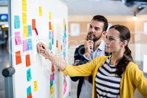 Colleagues looking at white board