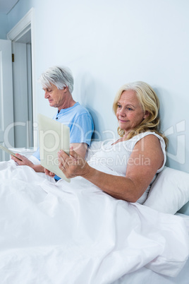 Retired couple using tablets