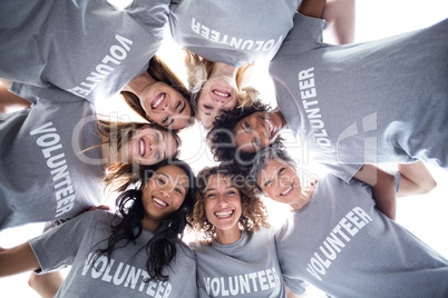 Happy volunteers forming a huddle