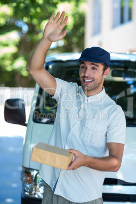 Smiling man waving hand