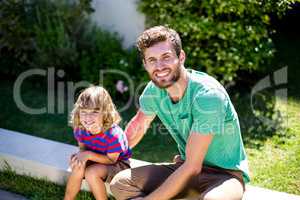 Father with son sitting in backyard