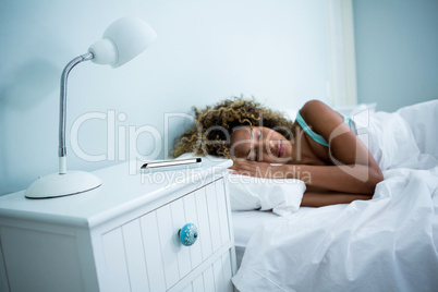 Young woman sleeping on bed