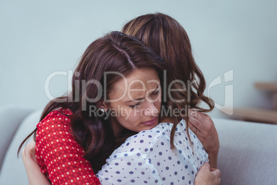 Depressed woman embracing her friend