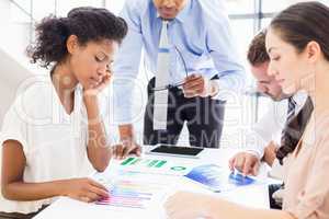 Businesspeople looking at reports in meeting