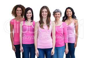 Smiling women in pink outfits posing for breast cancer awareness