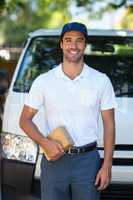Happy delivery person holding cardboard box