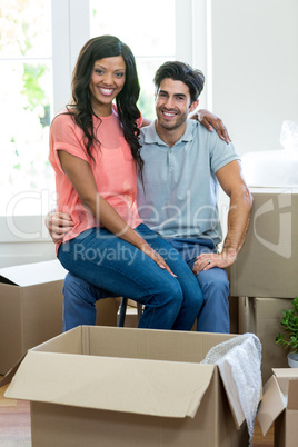 Young woman sitting on lap of a man and smiling at camera