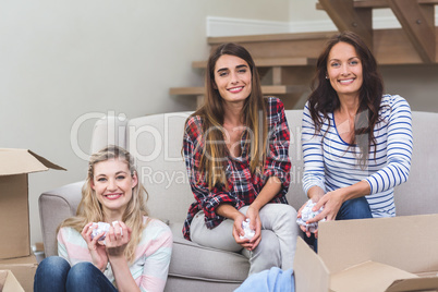 Friends holding packing peanuts in their new house