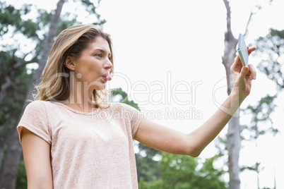 Smiling woman taking selfies