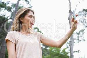 Smiling woman taking selfies