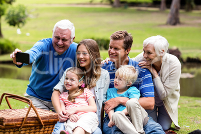 Multi-generation family taking a selfie in the park