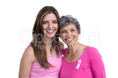 Smiling women in pink outfits posing for breast cancer awareness