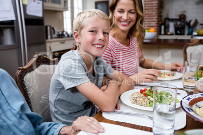 Portrait of boy having meal with his family