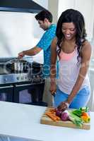Young couple cooking food together in kitchen