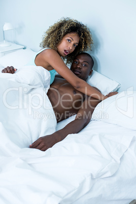 Young couple embracing each other on bed