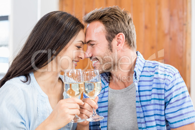 Young couple toasting wine glasses